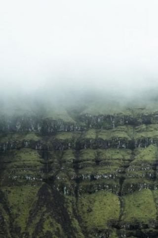 Abstract Rock Formations Covered In Fog On The Faroe Islands