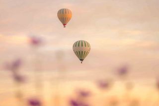 Hot air balloons in the sky at sunrise Melissa Peltenburg