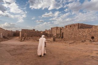 Man Walks Through The Ancient Town Ouadane