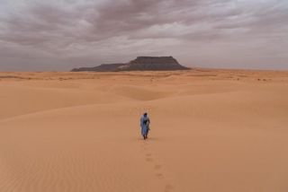 Walking to amountain in the Sahara